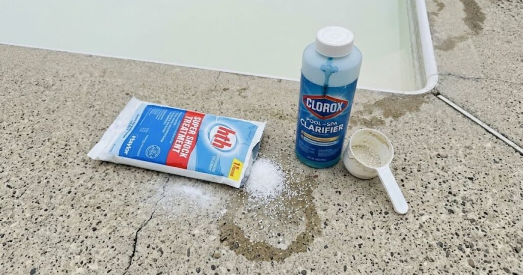 HTH pool shock bag and Clorox pool clarifier bottle on concrete pool deck for treating cloudy white pool water after shock treatment